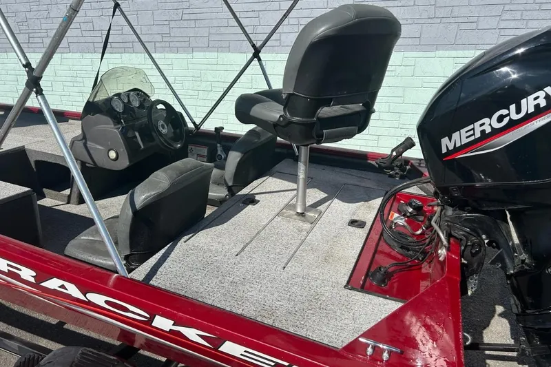 Slide: The Image of 2020 Bass Tracker Pro 170 boat interior with Mercury engine, featuring seating and steering console. - 7