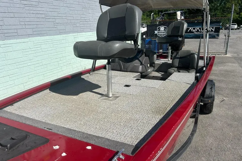 Slide: The Image of 2020 Bass Tracker Pro 170 boat with seating, red exterior, and gray interior. - 8