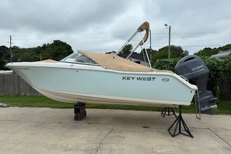 The Image of 2026 Key West 239 FS boat on trailer, parked outdoors, clear sky background. - 0