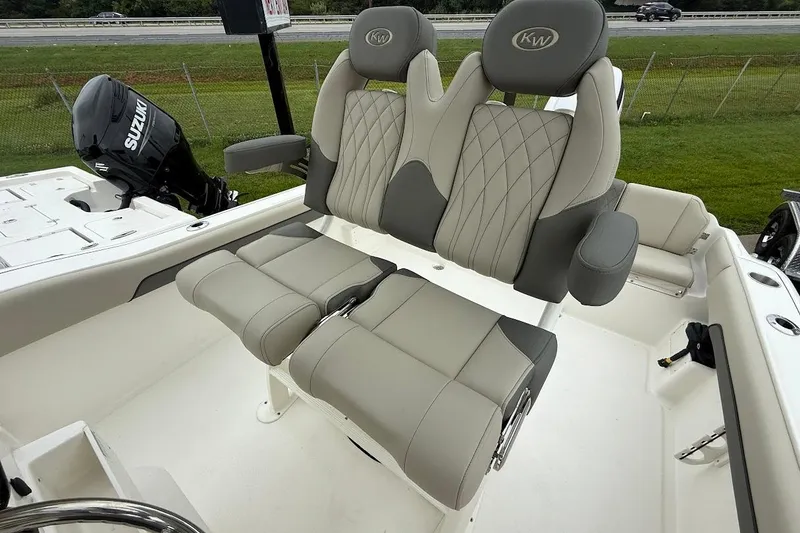 Slide: The Image of 2026 Key West 239 FS boat interior with dual seats and Suzuki outboard motor. - 11