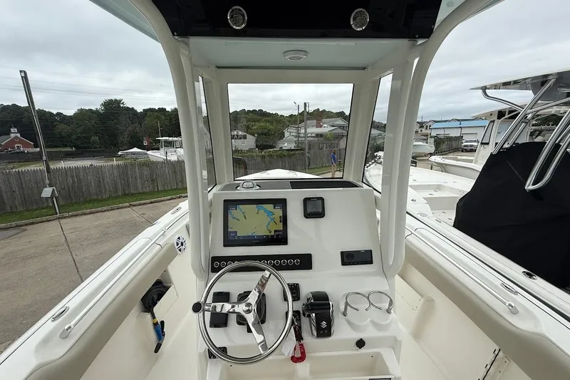 Slide: The Image of 2026 Key West 239 FS boat dashboard with navigation screen and steering wheel. - 12