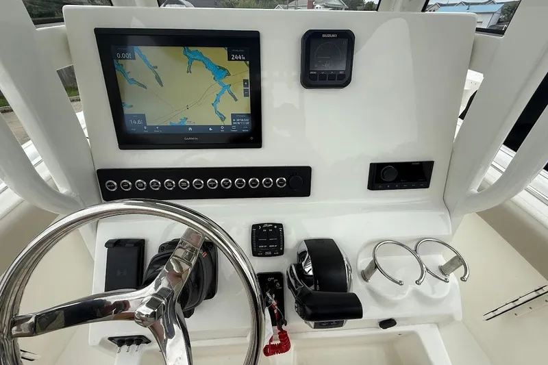 Slide: The Image of 2026 Key West 239 FS boat dashboard with navigation screen and controls. - 13