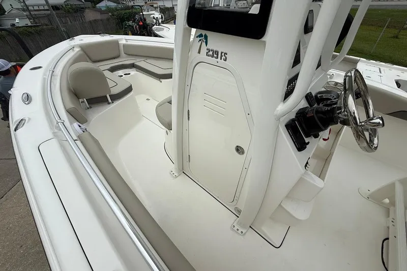 Slide: The Image of 2026 Key West 239 FS boat interior with steering wheel and seating area. - 15