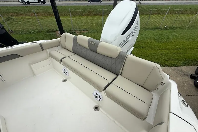Slide: The Image of 2026 Key West 239 FS boat interior with beige seating and Suzuki outboard motor. - 6