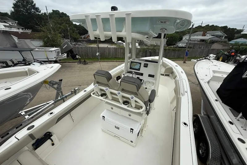 Slide: The Image of 2026 Key West 239 FS boat interior with dual seats and control panel, docked outdoors. - 8