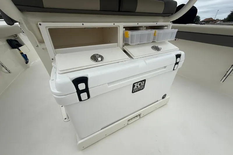 Slide: The Image of 2026 Key West 239 FS boat storage area with cooler and compartments. - 9