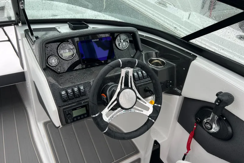 Slide: The Image of Steering console of 2026 Monterey M-225 boat with modern controls and navigation system. - 11