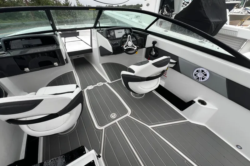 Slide: The Image of 2026 Monterey M-225 boat interior with modern dashboard, seating, and sleek design. - 18