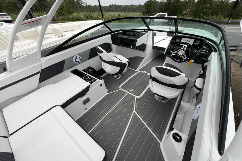 Slide: The Image of 2026 Monterey M-225 boat interior with sleek seating, modern dashboard, and stylish design. - 19