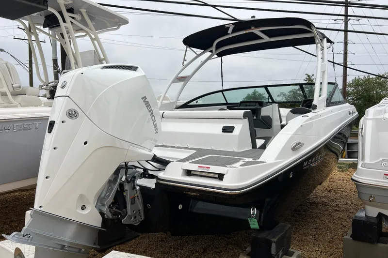 Slide: The Image of 2026 Monterey M-225 boat with Mercury outboard engine, displayed on gravel lot. - 4