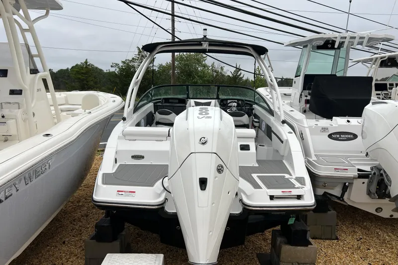 Slide: The Image of 2026 Monterey M-225 boat displayed outdoors, surrounded by other boats. - 5