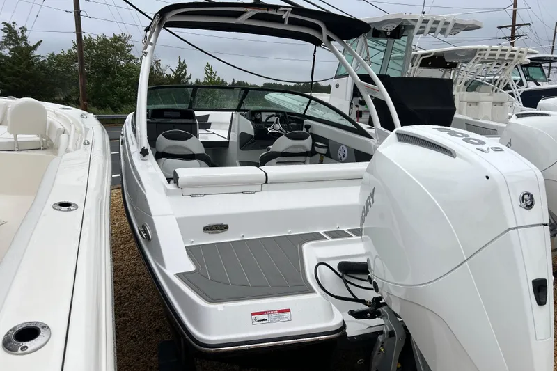 Slide: The Image of 2026 Monterey M-225 boat with Mercury outboard engine, docked alongside other boats. - 7