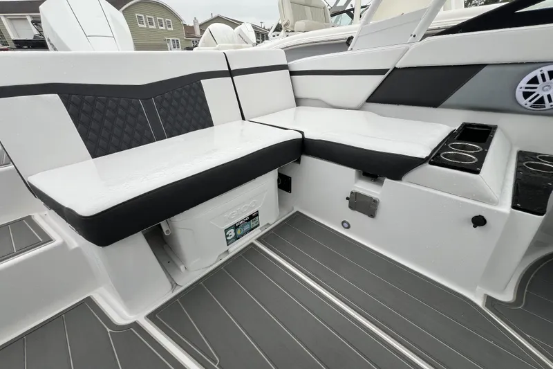 Slide: The Image of 2026 Monterey M-225 boat interior with cushioned seating and cup holders. - 9