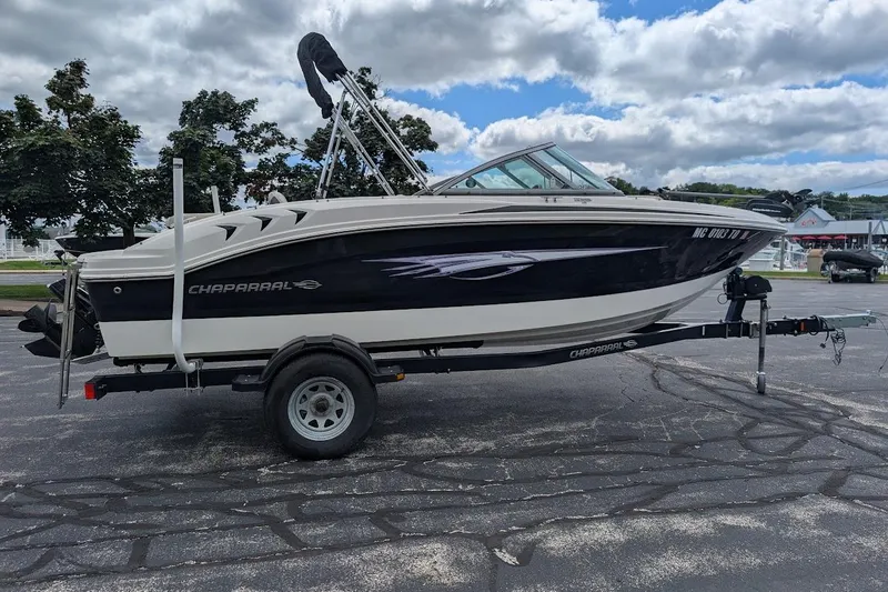 Slide: The Image of 2012 Chaparral 18 H2O Ski & Fish boat on trailer, parked outdoors. - 1