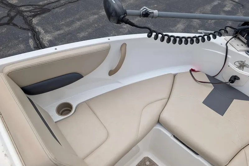 Slide: The Image of 2012 Chaparral 18 H2O Ski & Fish boat interior with beige seating and cup holder. - 12