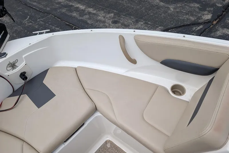 Slide: The Image of 2012 Chaparral 18 H2O Ski & Fish boat interior with beige seating and cup holder. - 13