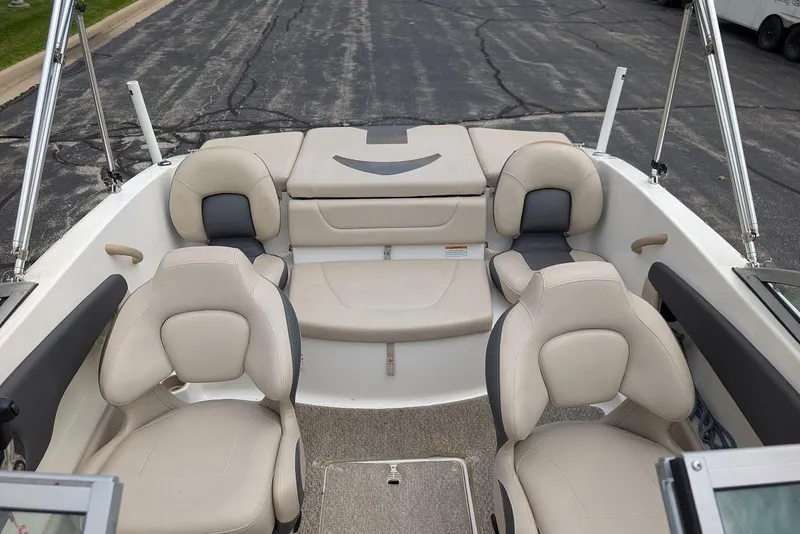 Slide: The Image of 2012 Chaparral 18 H2O Ski & Fish boat interior with beige seating and carpeted floor. - 14