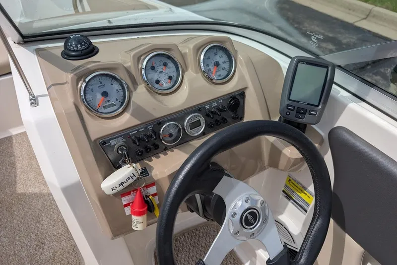 Slide: The Image of Control panel of 2012 Chaparral 18 H2O Ski & Fish boat with gauges and steering wheel. - 17