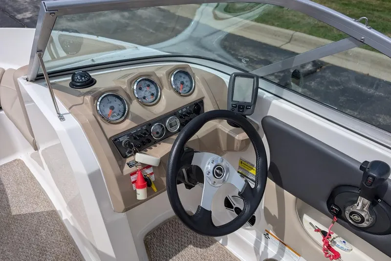 Slide: The Image of 2012 Chaparral 18 H2O Ski & Fish boat dashboard with steering wheel and gauges. - 19