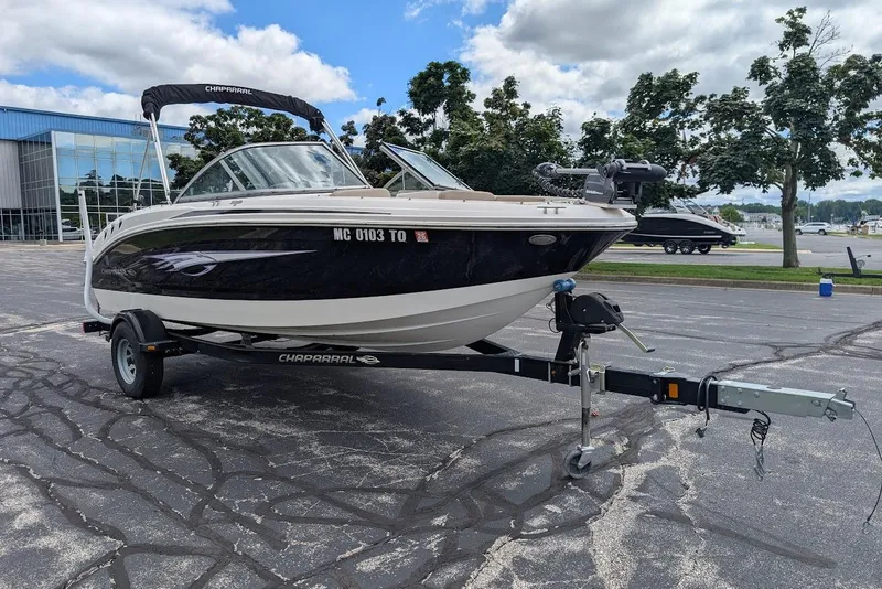 Slide: The Image of 2012 Chaparral 18 H2O Ski & Fish boat on trailer, parked outdoors. - 2