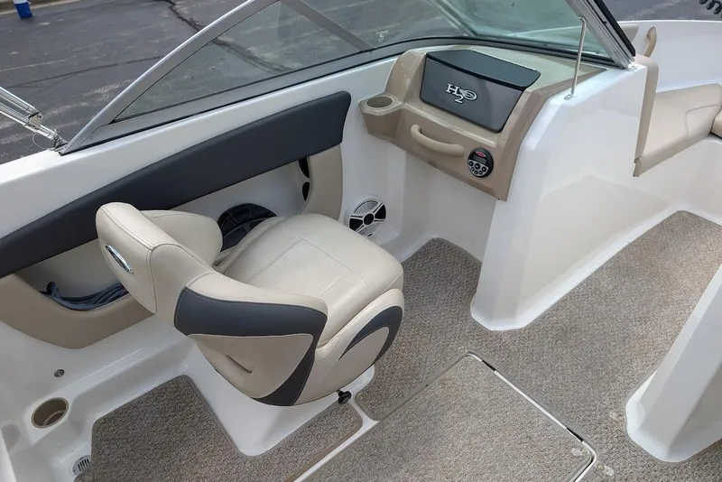 Slide: The Image of 2012 Chaparral 18 H2O Ski & Fish boat interior with beige seating and dashboard. - 21