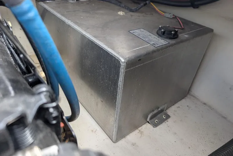 Slide: The Image of 2012 Chaparral 18 H2O Ski & Fish boat fuel tank with blue hose connection. - 28