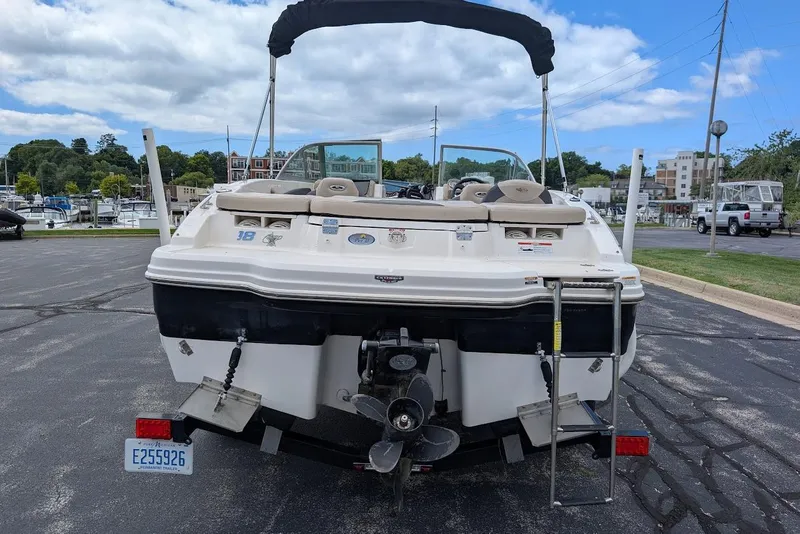 Slide: The Image of 2012 Chaparral 18 H2O Ski & Fish boat, rear view, parked near marina. - 4