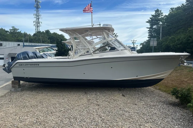 The Image of 2022 Grady-White Freedom 275 boat on display with American flag in background. - 0
