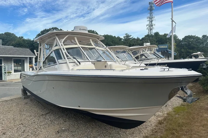 Slide: The Image of 2022 Grady-White Freedom 275 boat displayed outdoors with American flag. - 1