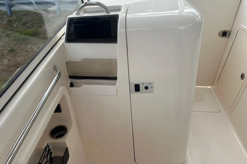 Slide: The Image of 2022 Grady-White Freedom 275 boat interior with sleek white console design. - 10