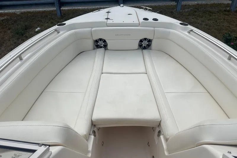 Slide: The Image of 2022 Grady-White Freedom 275 boat interior with white cushioned seating. - 11