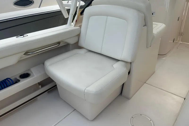 Slide: The Image of 2022 Grady-White Freedom 275 boat interior with white cushioned seating. - 12