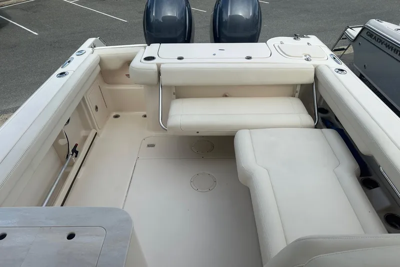 Slide: The Image of 2022 Grady-White Freedom 275 boat interior with white seating and dual engines. - 14