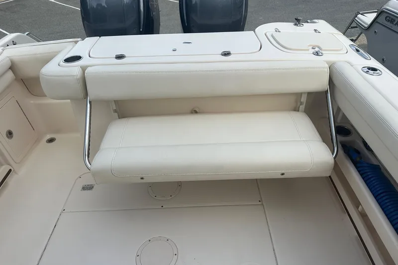 Slide: The Image of 2022 Grady-White Freedom 275 boat interior with foldable seating and storage compartments. - 15