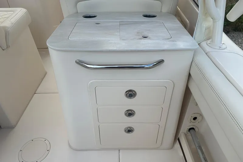 Slide: The Image of 2022 Grady-White Freedom 275 boat interior with storage drawers and countertop. - 18