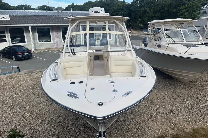 Slide: The Image of 2022 Grady-White Freedom 275 boat displayed outdoors, featuring spacious seating and Garmin equipment. - 2