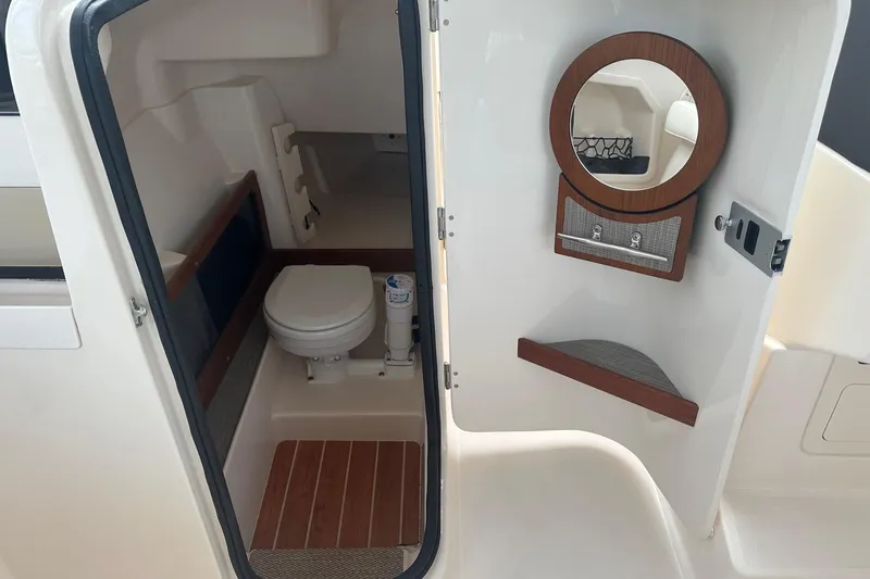 Slide: The Image of 2022 Grady-White Freedom 275 boat interior with toilet and mirror. - 20