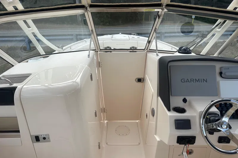 Slide: The Image of 2022 Grady-White Freedom 275 boat cockpit with Garmin navigation system. - 6