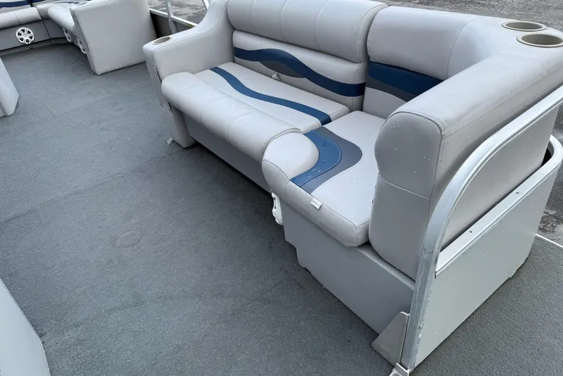 Slide: The Image of 1999 Sun Tracker PARTY BARGE 25 interior with gray and blue seating. - 6