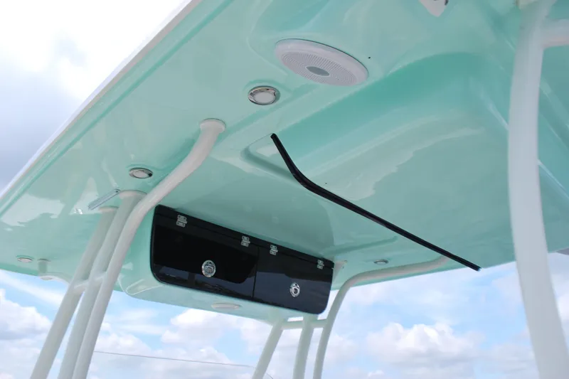 Slide: The Image of 2022 Key West 263 FS boat T-top with speakers and storage compartment. - 11