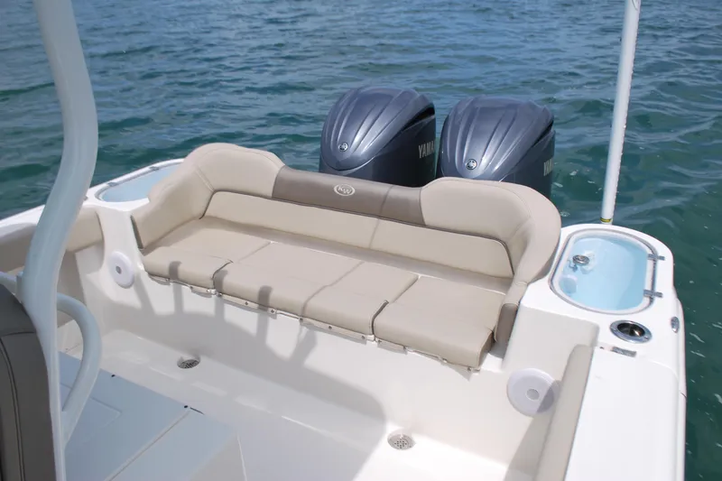 Slide: The Image of 2022 Key West 263 FS boat with beige seating and dual Yamaha engines on water. - 15