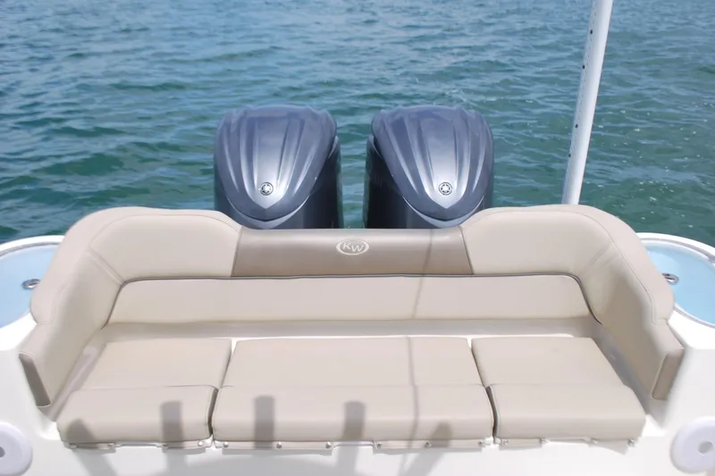 Slide: The Image of 2022 Key West 263 FS boat with dual engines and cushioned seating on water. - 16