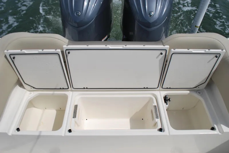 Slide: The Image of 2022 Key West 263 FS boat with open storage compartments and dual engines. - 17