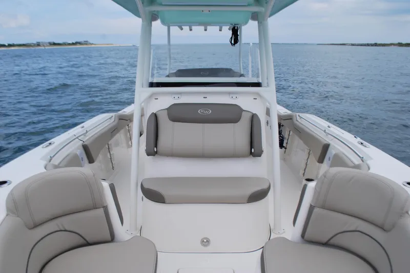 Slide: The Image of 2022 Key West 263 FS boat interior with cushioned seating on open water. - 7