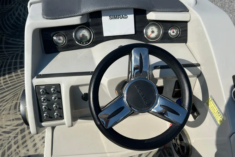 Slide: The Image of Steering console of 2016 Crest Classic 250 SLR2 boat with Simrad display and controls. - 16