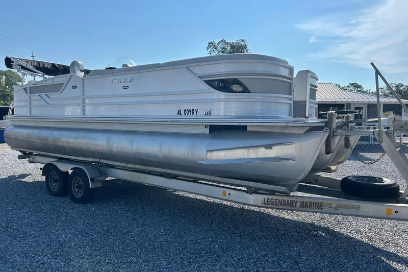 Slide: The Image of 2016 Crest Classic 250 SLR2 pontoon boat on trailer, parked on gravel. - 7