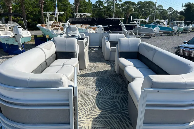 Slide: The Image of 2016 Crest Classic 250 SLR2 pontoon boat with spacious seating, parked in a marina. - 8