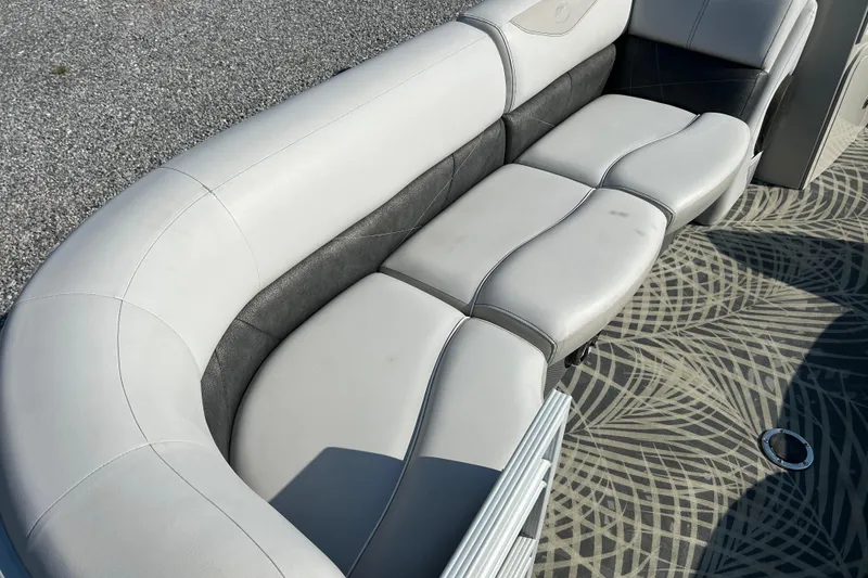 Slide: The Image of 2016 Crest Classic 250 SLR2 boat interior with curved seating and patterned flooring. - 9