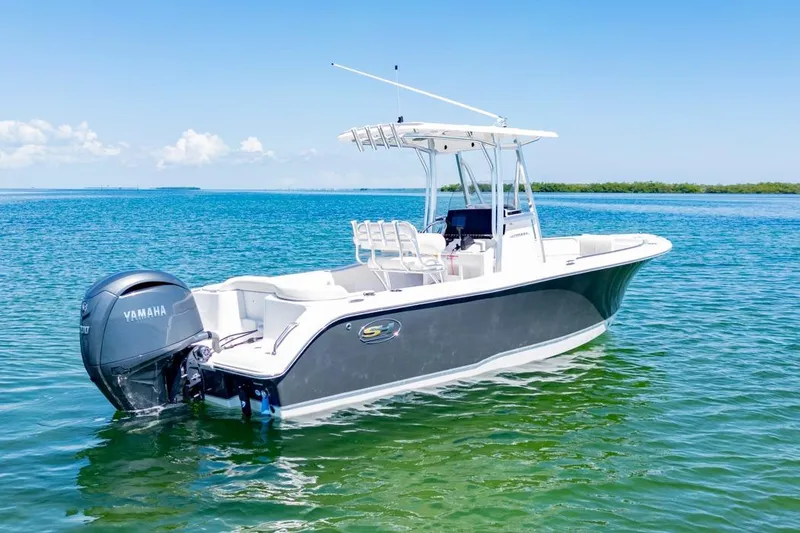 Slide: The Image of 2026 Sea Hunt Ultra 234 boat on clear blue water, featuring Yamaha engine. - 1