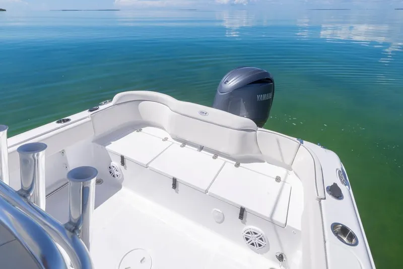 Slide: The Image of 2026 Sea Hunt Ultra 234 boat with Yamaha engine on calm water. - 11